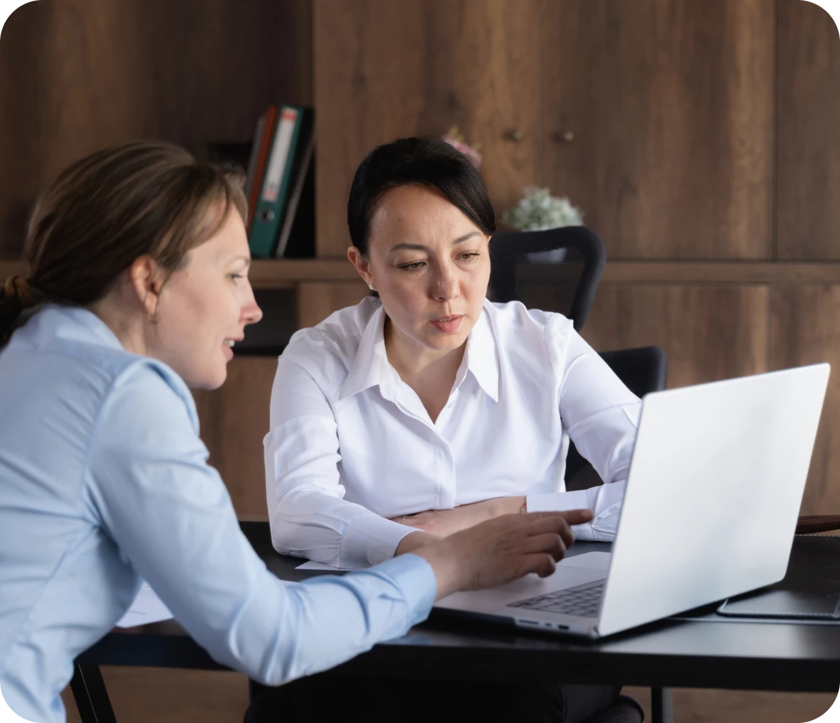 Two women collaborating on a laptop